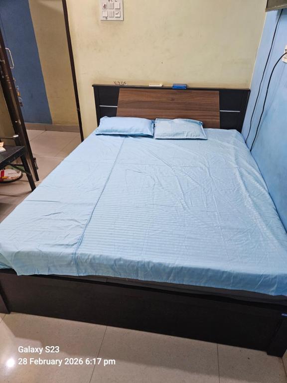 a bed in a room with a blue comforter at Viswam residency in Rāyachoti