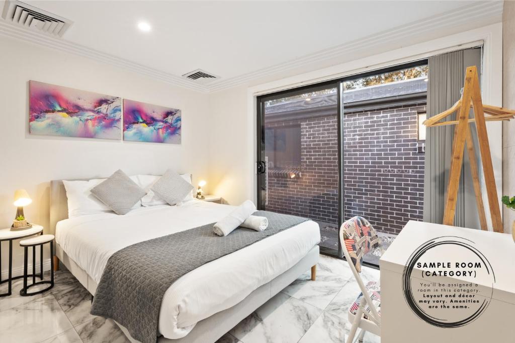 a bedroom with a bed and a large window at Boutique Queen Room - Centrally Located at Glenfield - Shared Bathroom in Glenfield