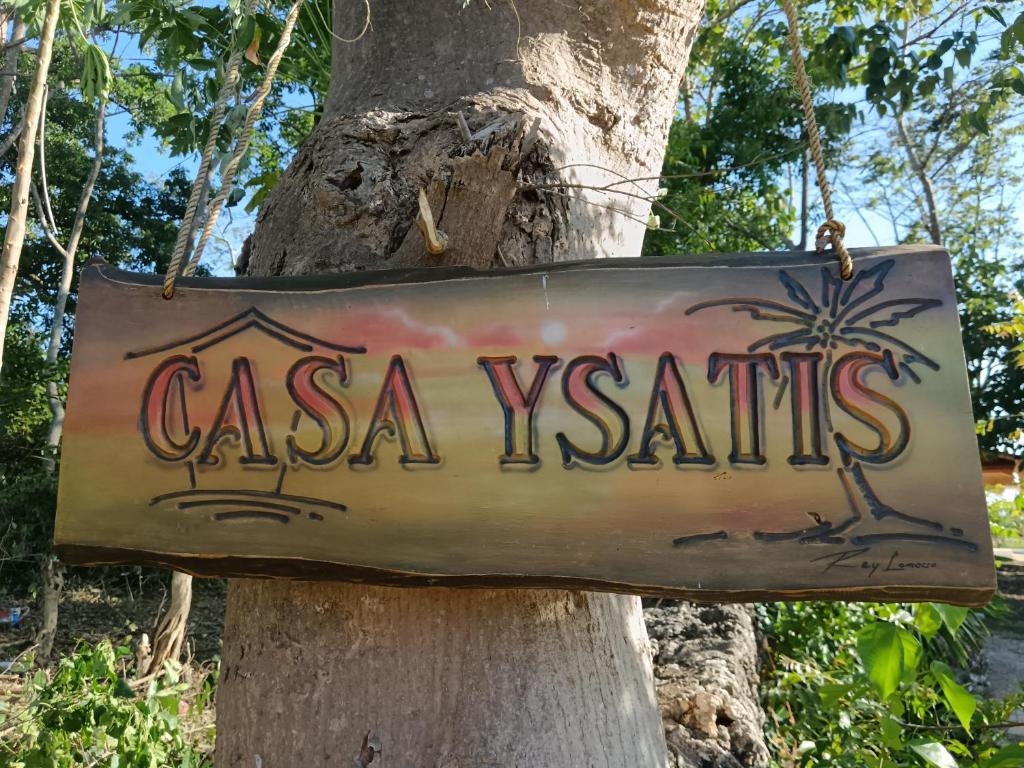 a sign that says casa vesta hanging on a tree at Casa ysatis in Lazi