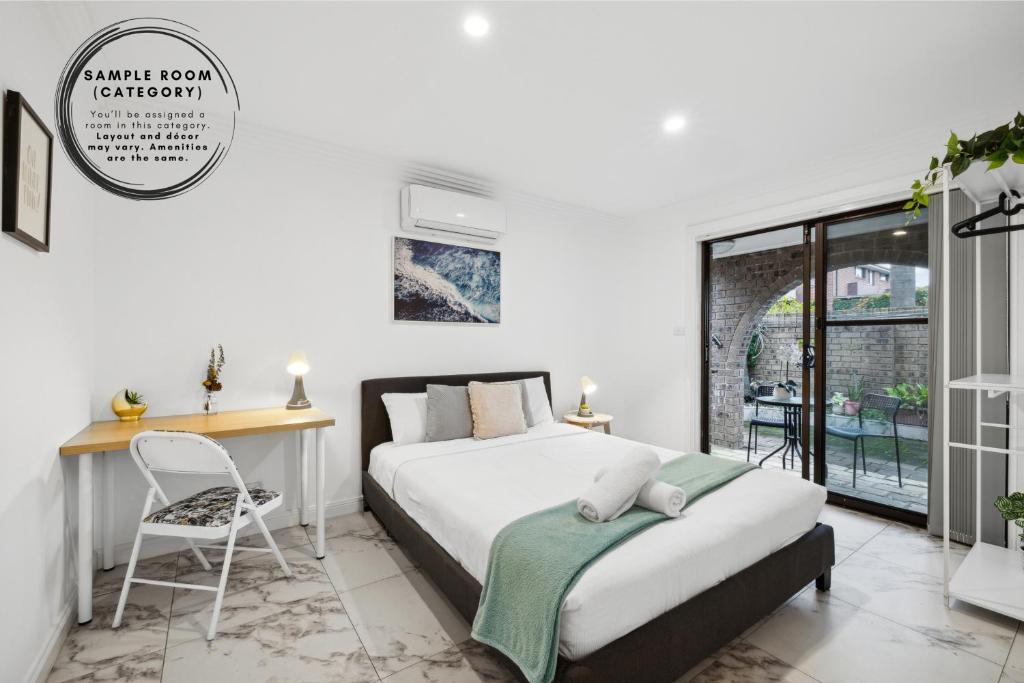 a bedroom with a bed and a desk and a chair at Quaint Double Room - Centrally Located at Glenfield - Shared Bathroom in Glenfield