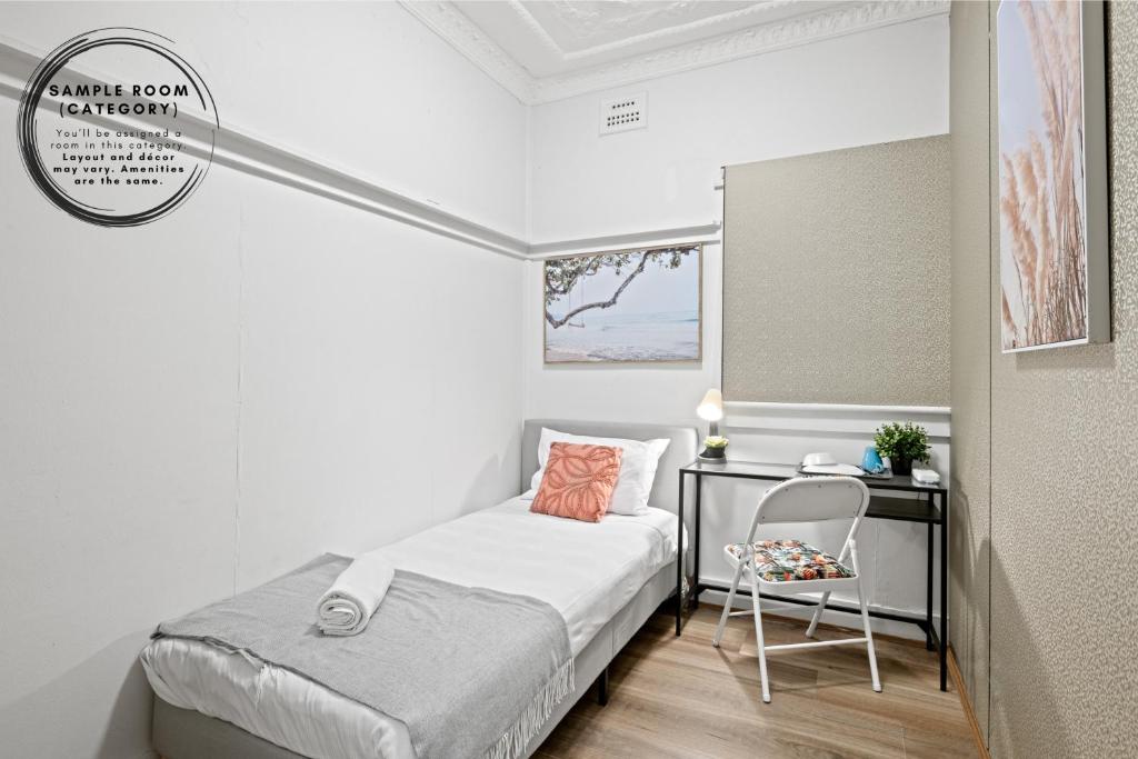a small bedroom with a bed and a chair at Boutique Single Room - Centrally Located at Granville - Shared Bathroom in Sydney