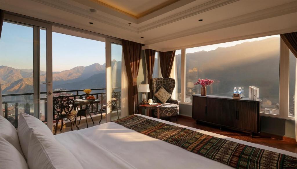 a bedroom with a bed and a balcony with mountains at Sapa Horizon Hotel & Skybar in Sapa