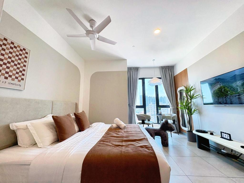 a bedroom with a large bed with a ceiling fan at Le Arch Suite - Georgetown Komtar View Studio in George Town
