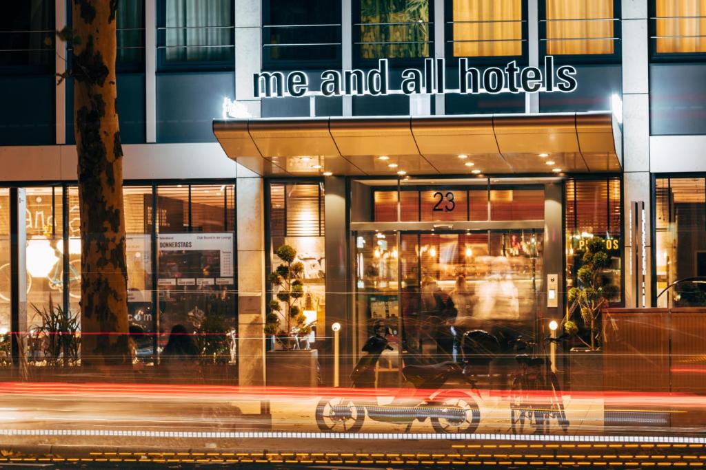 a me and all industries store on a street at night at Me and All Hotel Dusseldorf, by Hyatt in Düsseldorf