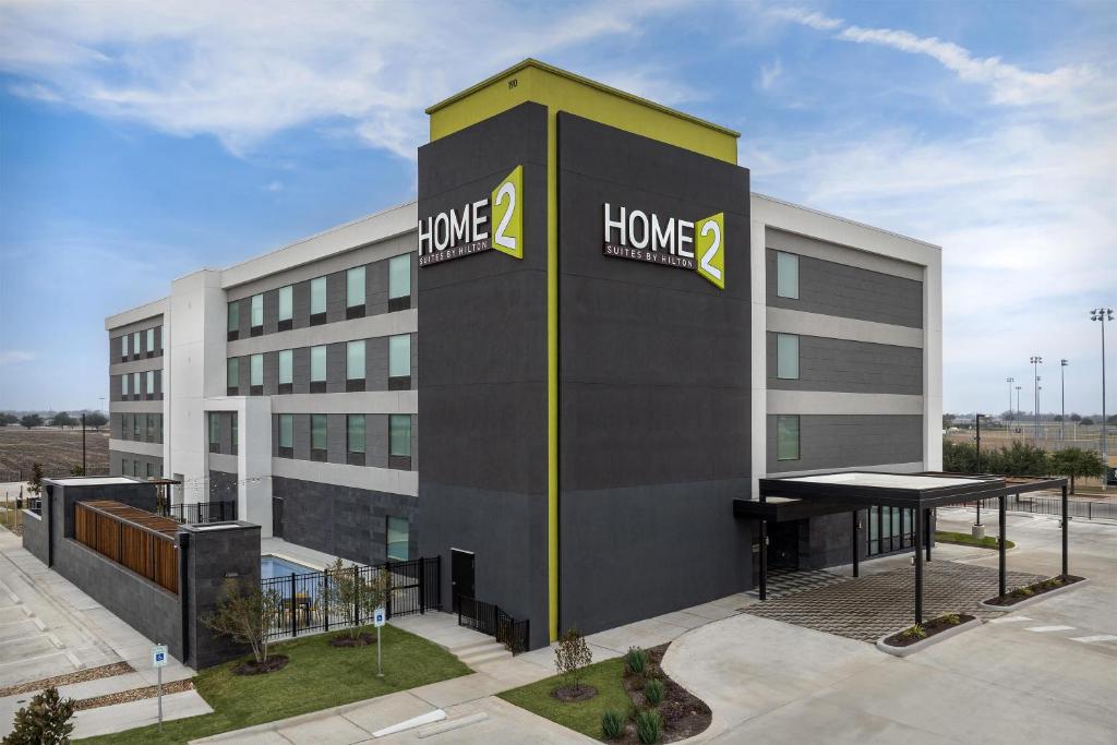 a home office building with a sign on it at Home2 Suites By Hilton Taylor in Taylor