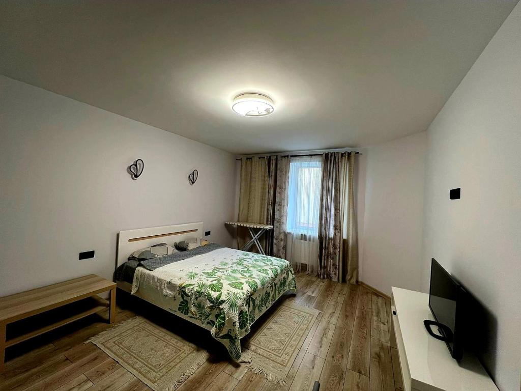 a bedroom with a bed and a flat screen tv at Апартаменти біля АС-1 Зацепи in Lutsk