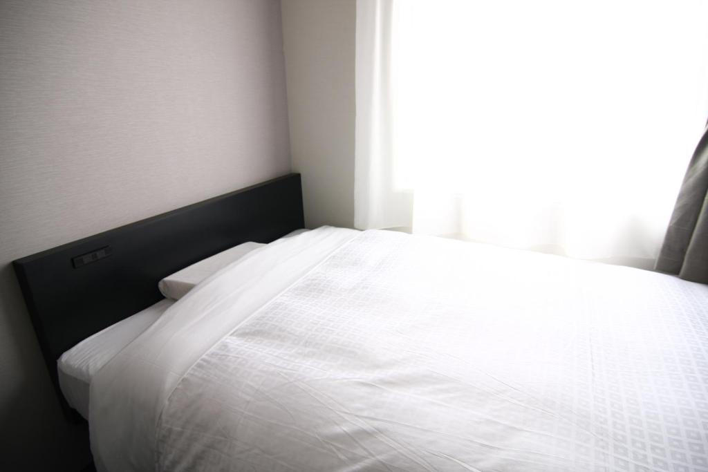Postel nebo postele na pokoji v ubytování Hotel Crown Hills Kimitsu