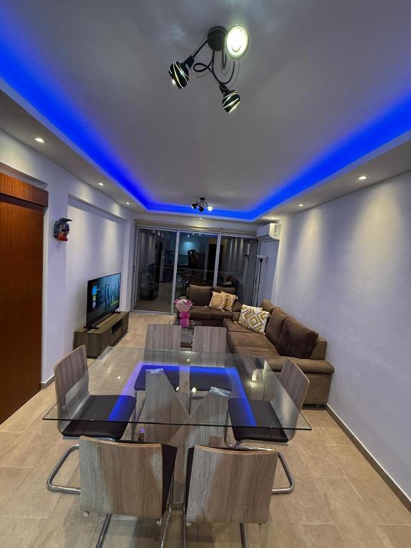 a living room with a table and a couch at 777 Stars in Paphos