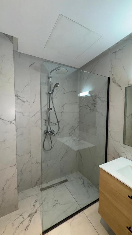 a bathroom with a shower with a glass door at CfC in Casablanca