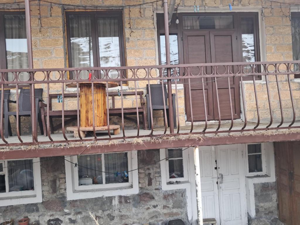 a balcony with a table and chairs on a building at Hotel kazbegi1 in Kazbegi