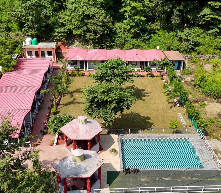an aerial view of a house with a swimming pool at Ekantam Riverside Resort in Bijni