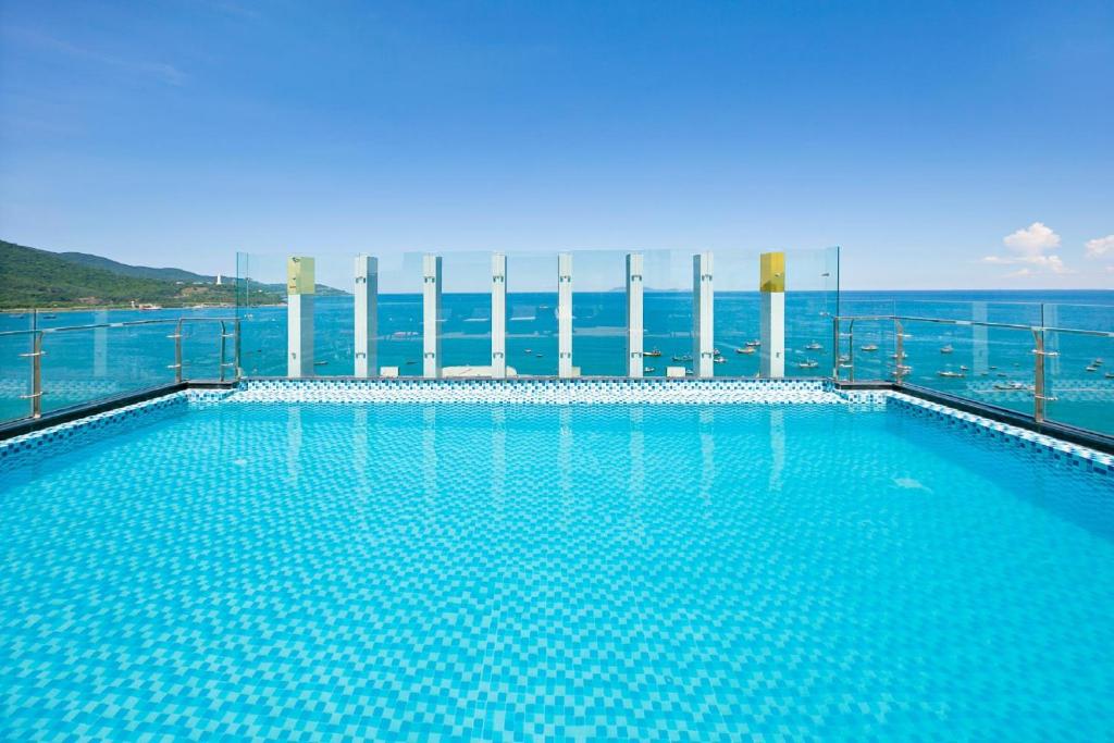 A rooftop-style pool looks directly out over the sea.