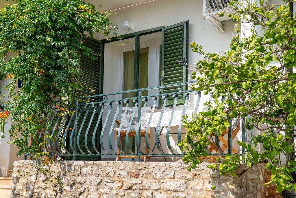 a balcony of a house with two chairs on it at Nikola studio in Božava