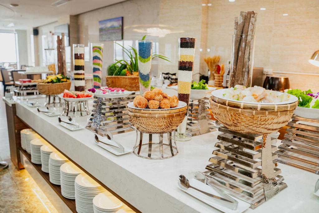 A polished buffet counter presents pastries, salads, fruit and plated breakfast items.