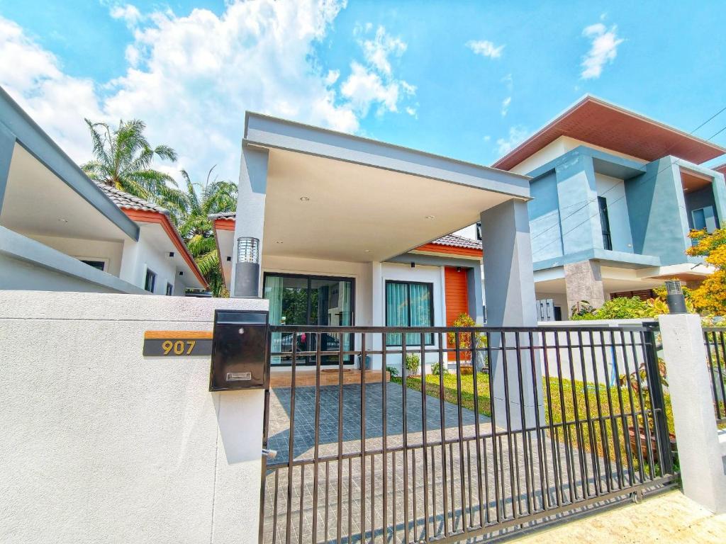 a house with a gate in front of it at Tanner House Krabi in Ban Klang