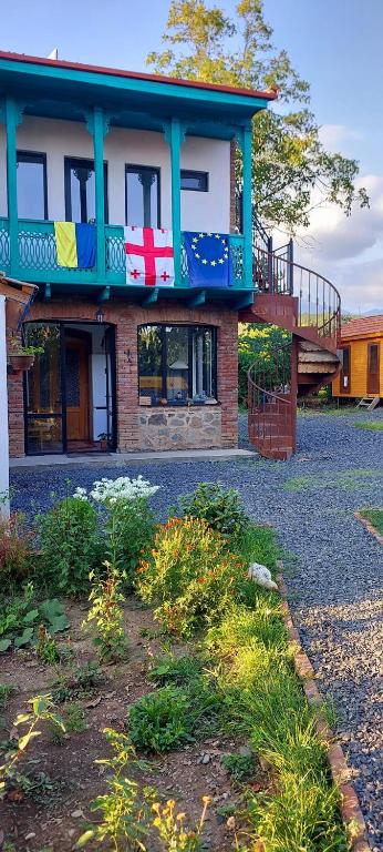 a house with a flag on the side of it at AnaVino in Kvareli