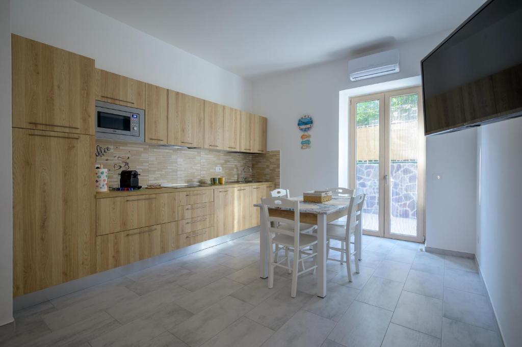 a kitchen with wooden cabinets and a table with stools at Danys home in Ischia Town