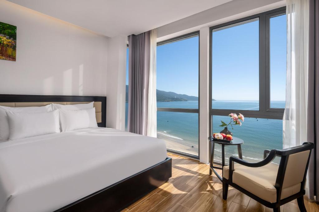 a bedroom with a bed and a view of the ocean at DAO NGOC BEACH HOTEL Da Nang in Danang