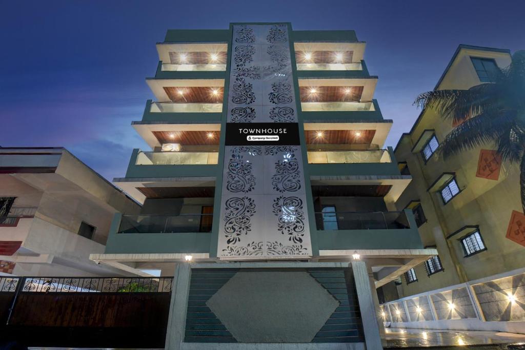 a tall building with a sign on the side of it at Super Townhouse Pimple Nilakh Pune in Dāpuri