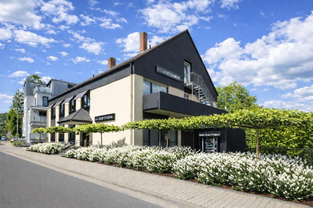 a building with white flowers in front of it at Hotel Am Martinsberg in Andernach
