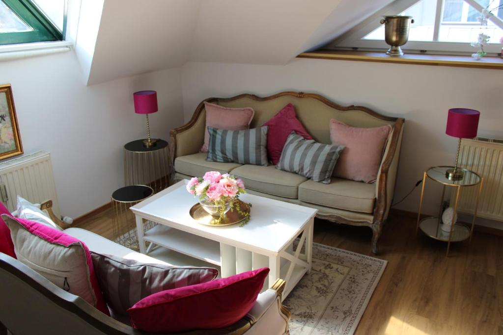 a living room with a couch and a table at Hideaway Palais Auersperg in Salzburg