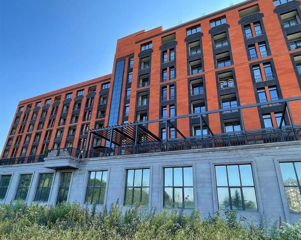 a large red brick building with a fire escape on it at Alvina Complex in Tsaghkadzor