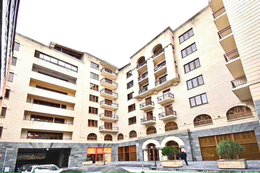 a large building with a car parked in front of it at Manul apartments in Yerevan