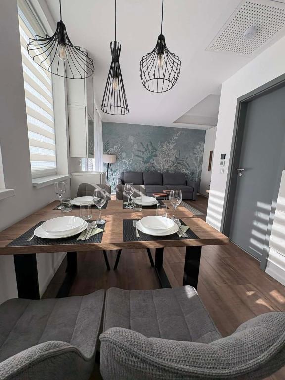 a dining room with a table and some chairs at H&H Apartman in Fonyód