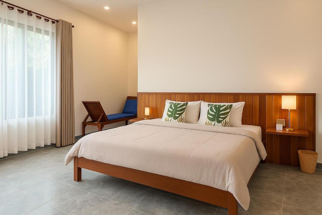 a bedroom with a large bed and a chair at Private Bungalow, Large Salt Water Pool & Jacuzzi, Super Fast WIFI 100Mbps in Phumĭ Kruŏs