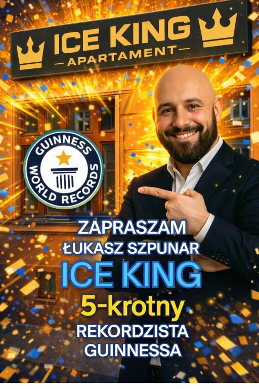 a man in a suit standing in front of a sign at ICE KING Apartament in Sandomierz