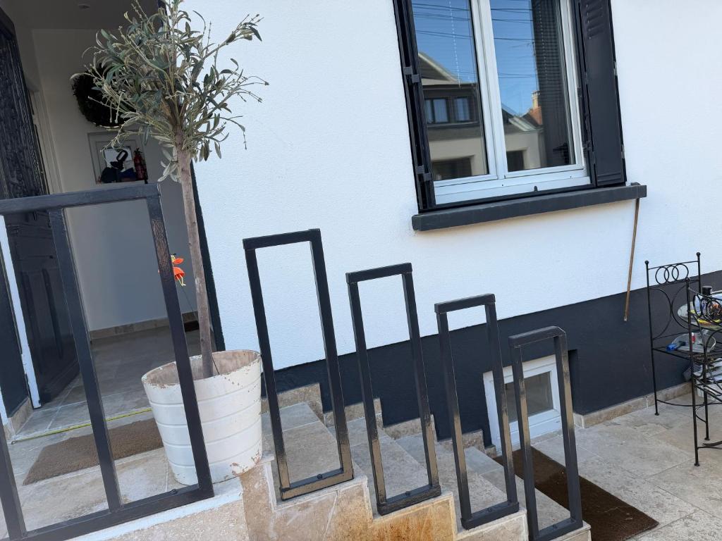a group of mirrors sitting next to a building at 13th private in Rueil-Malmaison