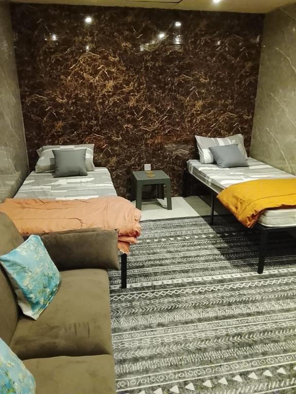 a room with two beds and a couch at DREAM Room , AJMAN in Ajman 