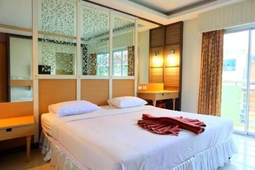 a bedroom with a large white bed with two pillows at PSHill in Ao Nang Beach