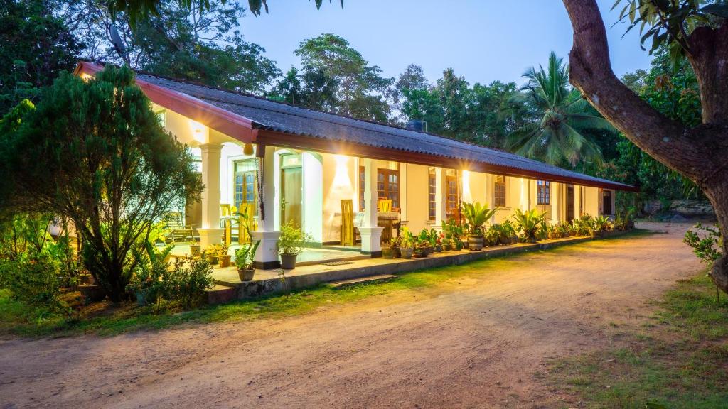 a house in the middle of a dirt road at Villa Swallow Nest in Sigiriya