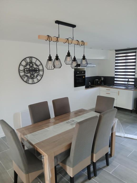 a dining room with a wooden table and chairs at L'Ancienne Etable in Gentelles