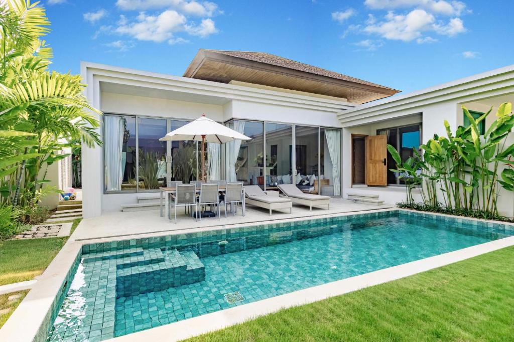 a swimming pool in front of a villa at Villa 24 3BR Trichada Breeze in Phuket