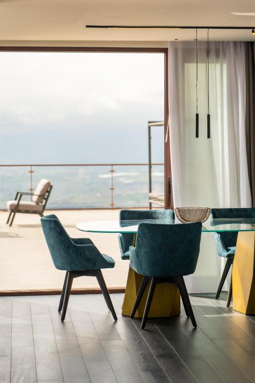 a dining room with a table and chairs and a balcony at Dimora Eledia in Taormina