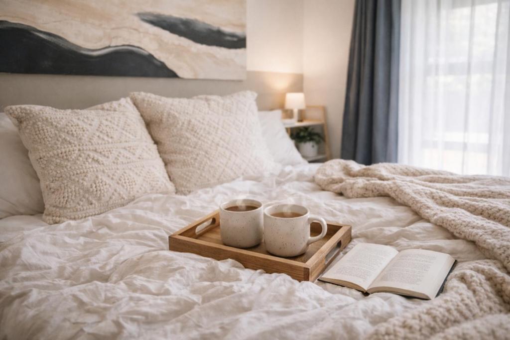 a tray with two cups and two books on a bed at The Halfway Homestead in Middelburg
