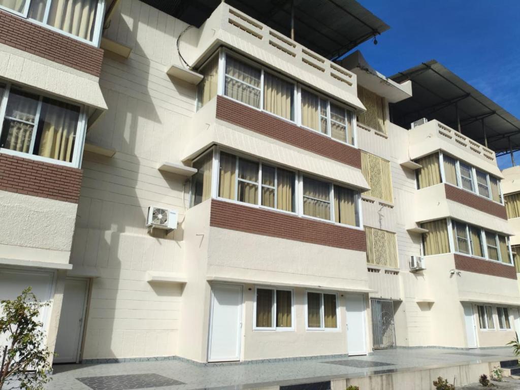 a building with white and brown at Sai Devine Abode Of SAI at Sri Sathya Sai ghaat in Rishīkesh