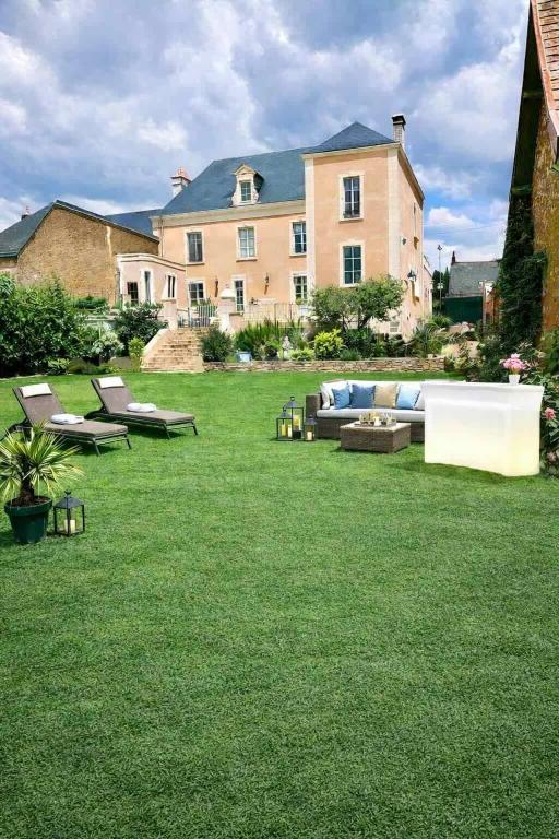 a large house with a couch and chairs in a yard at KVS concept Écommoy chambres haut de gamme proche circuit 24 heures Le Mans in Écommoy