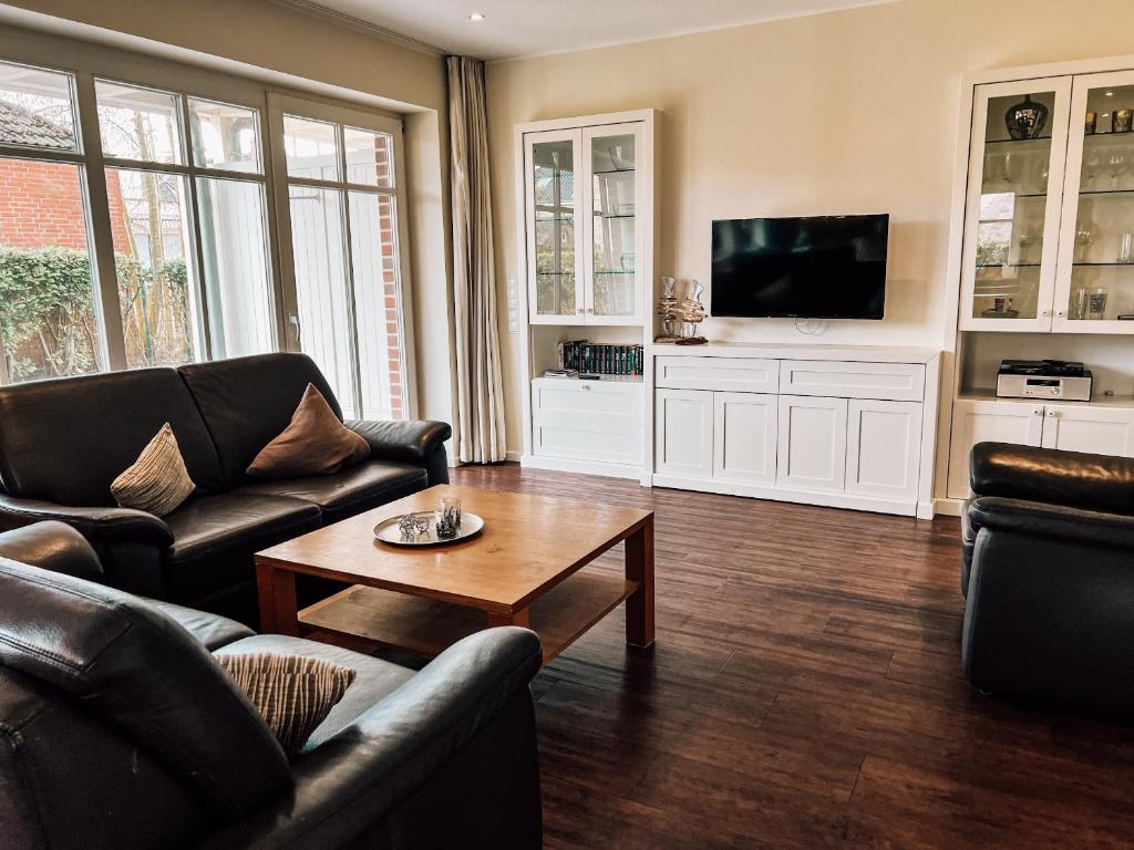 a living room with two couches and a coffee table at Feriendorf Marienhof C2 Marieke in Borkum