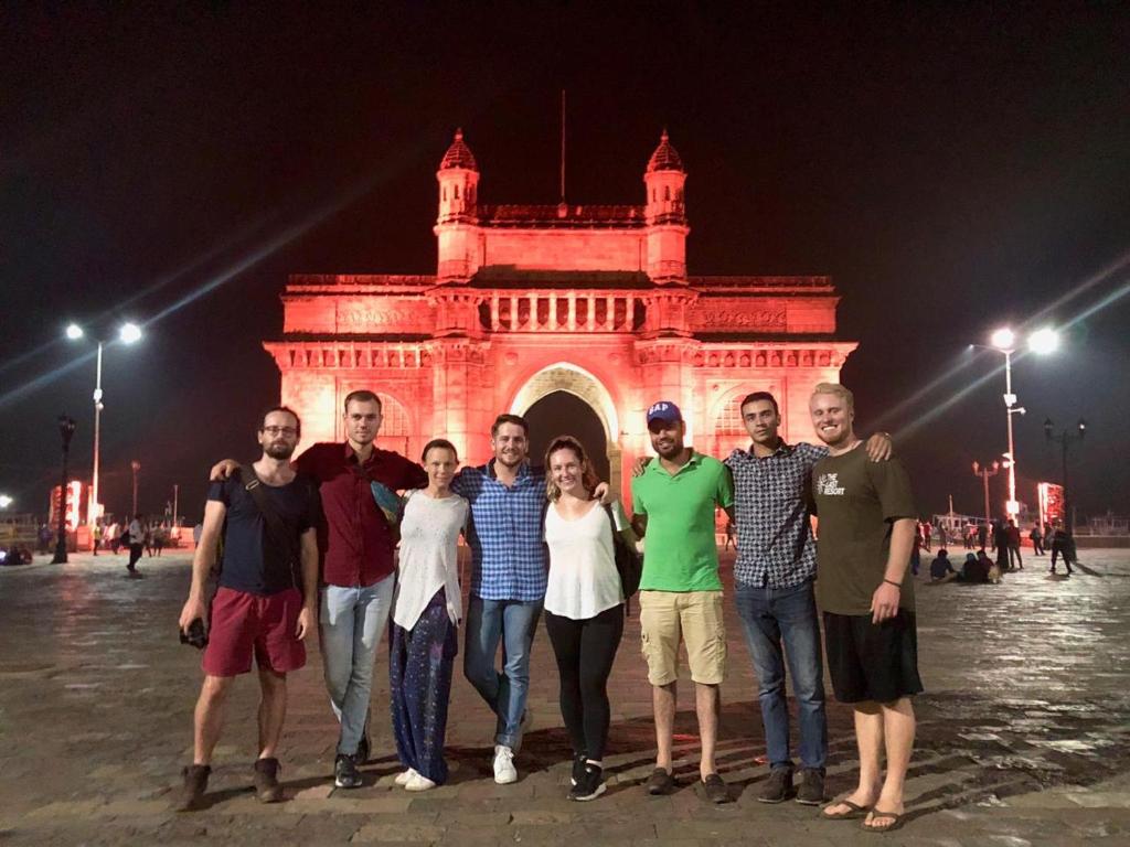 a group of people posing in front of a building at The BVM Hostel in Mumbai