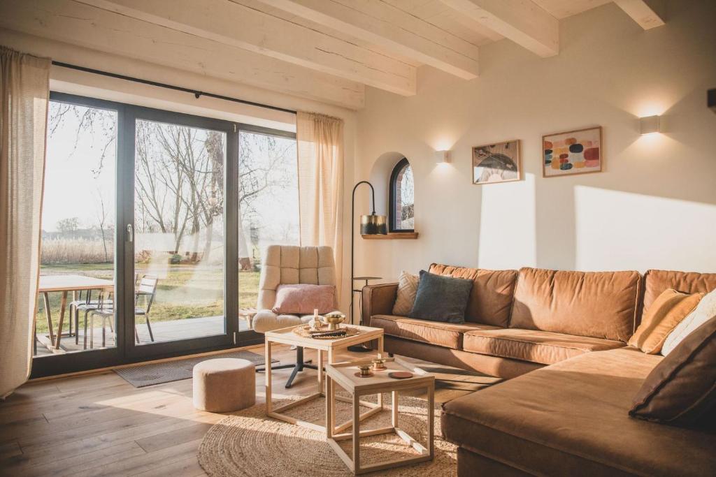 a living room with a couch and a table at Gulfhof Wangermeer 8 Maila in Hohenkirchen
