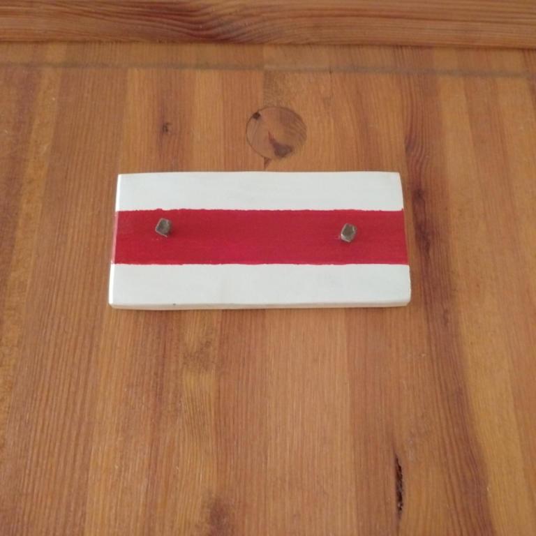 a red and white object on a wooden floor at Baza Warsztatowo-Edukacyjna K85 Komańcza in Komańcza