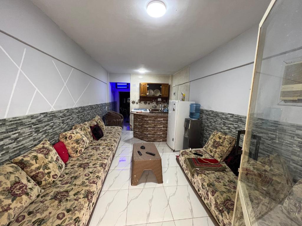 a living room with a couch and a table at شاليه بقريه روجينا العين السخنه in Ain Sokhna