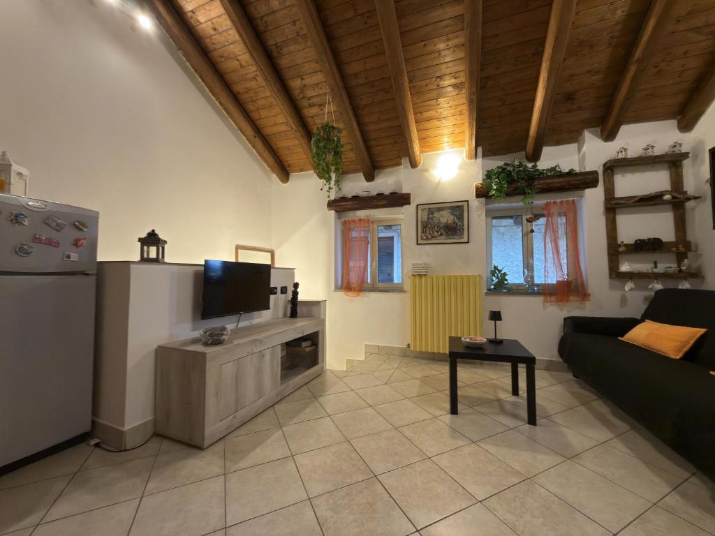 a living room with a couch and a tv at House A73 in Lezzeno