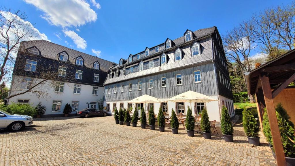 a large building with trees in front of it at Hotel Alte Mühle in Chemnitz