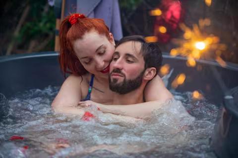 a man and a woman in a bath tub at Au Gré Des Lis - La Suite Du Chêne in Belval-sous-Châtillon