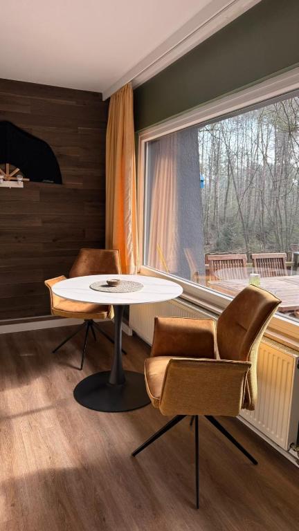 a room with a table and two chairs and a window at Ferienhaus mit Privatsauna in Lage