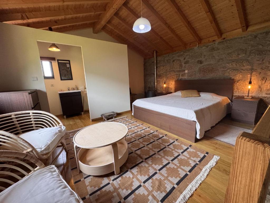 a bedroom with a bed and a table and chairs at Serena Nest 03 in Rio Douro